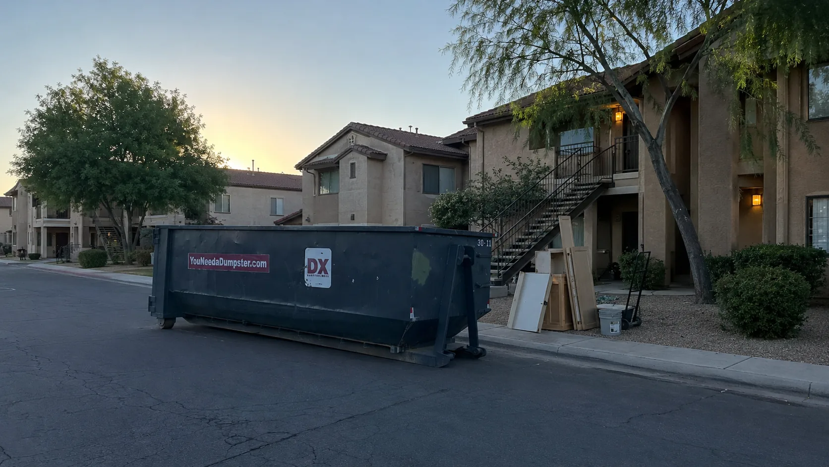 Dumpstr Xpress roll-off dumpster outside a Phoenix apartment renovation