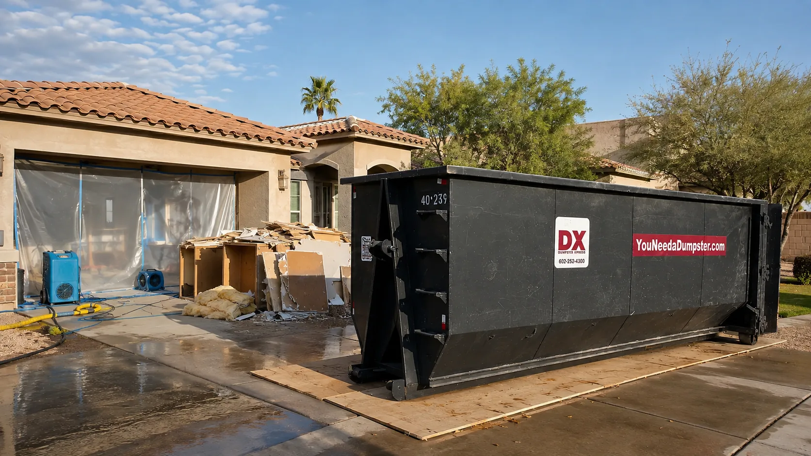 Dumpstr Xpress roll-off dumpster supporting water-damage restoration at a Phoenix home